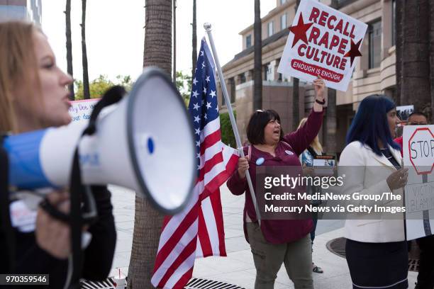 LezLi Logan, center, joins Santa Clara County leaders, volunteers and survivors at a recall rally outside of attorney James McManis' office in San...
