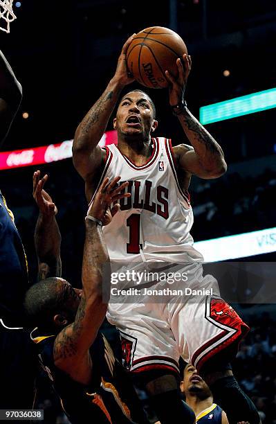 Derrick Rose of the Chicago Bulls gets called for a charge against Dahntay Jones of the Indiana Pacers at the United Center on February 24, 2010 in...