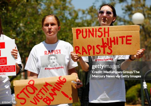 Zoe Gregozek and Hattie Dalzell, left to right, attend a protest calling for the impeachment of Santa Clara County Superior Court Judge Aaron Persky...