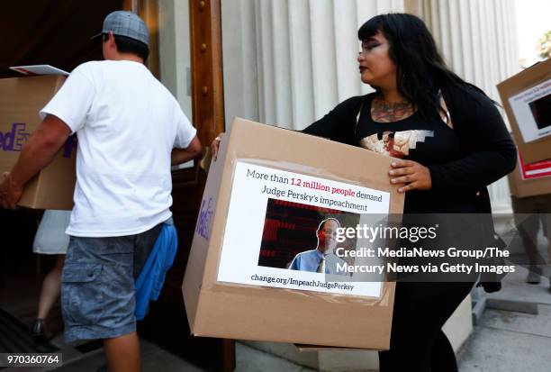 Rosemarie Ramirez carries a symbolic box of petitions calling for the impeachment of Santa Clara County Superior Court Judge Aaron Persky into the...