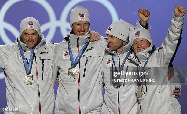 Norwegian Silver medallists Martin Johnsrud Sundby, Odd-Bjoern Hjelmeset, Lars Berger and Petter Northug are seen during the medal ceremony for the...