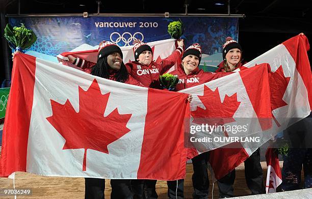 The Canada-1 women bobsleigh pilot Kaillie Humphries and brakeman Heather Moyse celebrate winning gold in the two-man bobsleigh event with Canada-2...