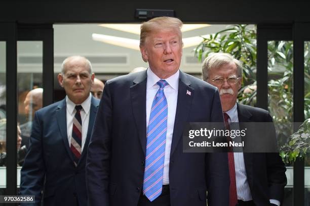 President Donald Trump leaves with Chief of Staff John Kelly and National Security Advisor John Bolton after holding a press conference ahead of his...