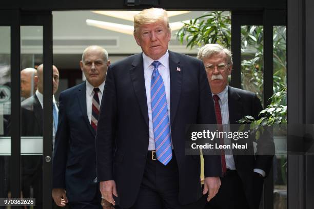 President Donald Trump leaves with Chief of Staff John Kelly and National Security Advisor John Bolton after holding a press conference ahead of his...