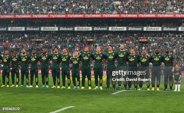 Captain Siya Kolisi of South Africa sings the national anthem alongside team mates prior to the first test between and South Africa and England at...