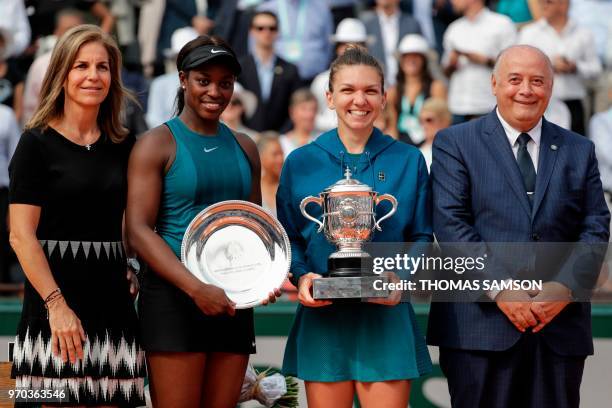 Romania's Simona Halep , poses with her trophy next to second placed Sloane Stephens of the US , French Tennis Federation President Bernard...