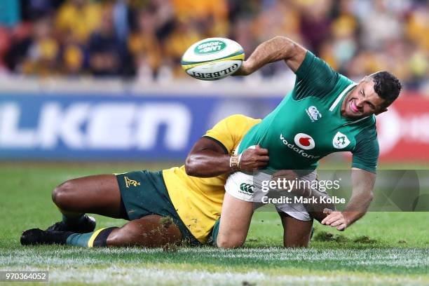 Rob Kearney of Ireland passes as he is tackled during the International Test match between the Australian Wallabies and Ireland at Suncorp Stadium on...