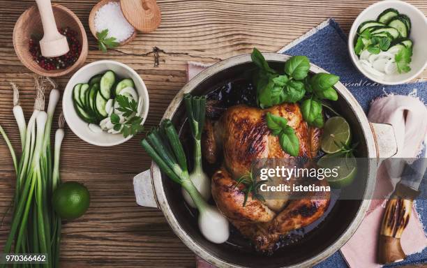 roasted chicken with green vegetables salad and fresh herbs - roast chicken table stock pictures, royalty-free photos & images