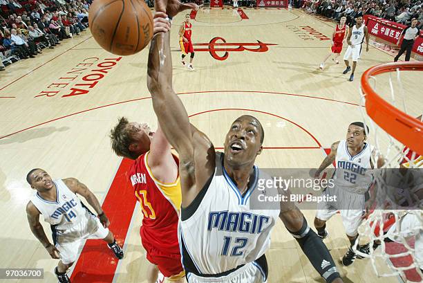 Dwight Howard of the Orlando Magic shoots the ball over David Anderson of the Houston Rockets on February 24, 2010 at the Toyota Center in Houston,...