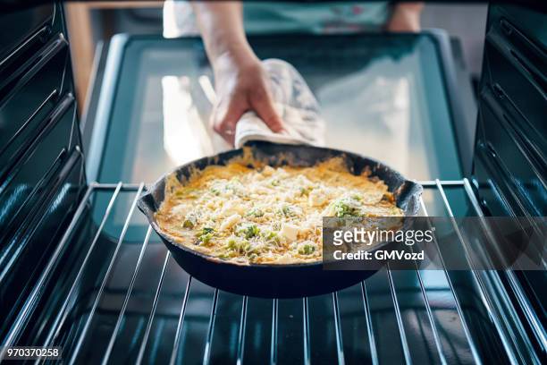 baking frittata with green asparagus, peas and parmesan in the oven - cast iron stock pictures, royalty-free photos & images