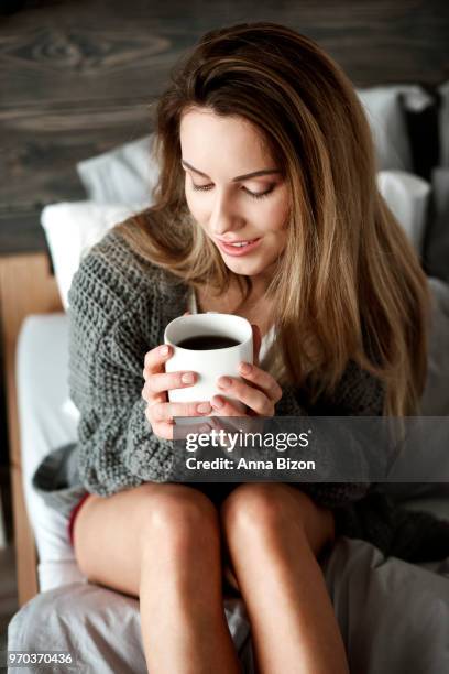 woman with coffee mug on bed. debica, poland - lazy poland stock pictures, royalty-free photos & images