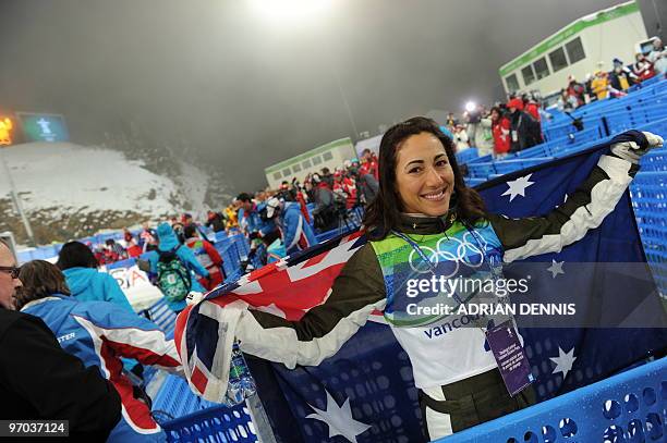 Australia's Lydia Lassila holds the Australian flag during the Freestyle Skiing women's aerial finals at Cypress Mountain, north of Vancouver during...