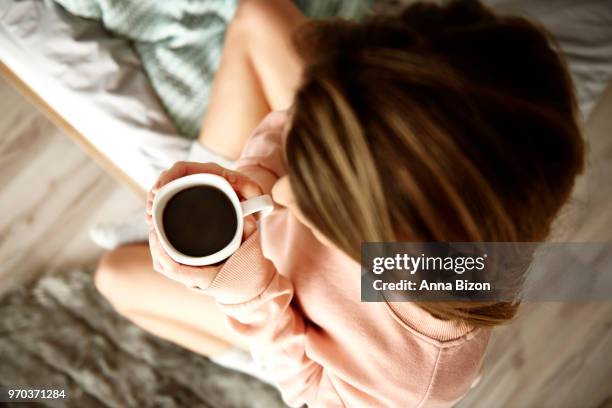 top view of woman drinking coffee in bed. debica, poland - lazy poland stock pictures, royalty-free photos & images