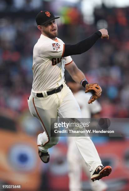 Evan Longoria of the San Francisco Giants makes an off balance throw to first base throwing out John Ryan Murphy of the Arizona Diamondbacks in the...