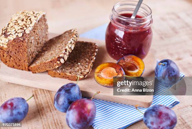 homemade plum jam with fresh bread on cutting board. debica, poland - marmalade sandwich stock pictures, royalty-free photos & images