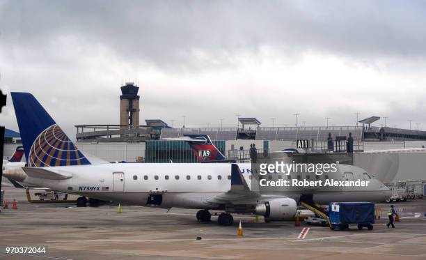 United Express Embraer ERJ-175LR commercial jet is serviced at a gate at Charlotte Douglas International Airport in Charlotte, North Carolina.