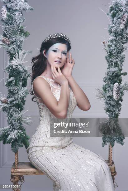 woman as snow maiden with crown on swing. debica, poland - frozen princess stock pictures, royalty-free photos & images