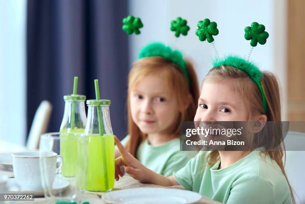 portrait of siblings with green juice sitting at the table. debica, poland - deely bopper stock pictures, royalty-free photos & images