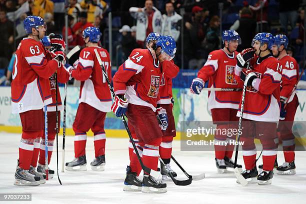 Players from the Czech Republic hang their heads as they stand on the ice after they lost 2-0 during the ice hockey men's quarter final game between...