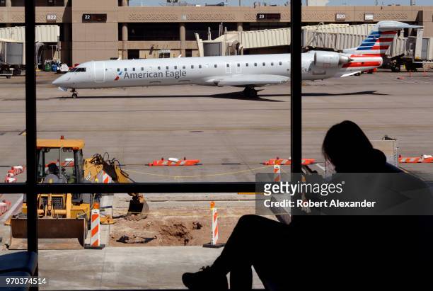 An American Eagle commercial aircraft taxis in front of the terminal at Phoenix Sky Harbor International Airport in Phoenix, Arizona.