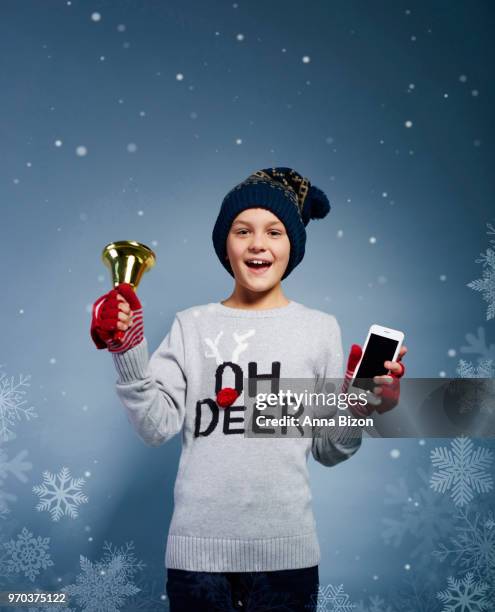 boy with christmas bell and mobile phone. debica, poland - bell boy stock-fotos und bilder