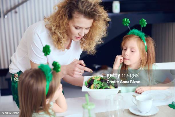portrait of mother giving children cookies. debica, poland - deely bopper stock pictures, royalty-free photos & images
