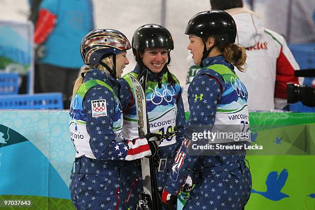 Lacy Schnoor of the United States talks with Emily Cook and Ashley Caldwell during the freestyle skiing ladies' aerials final on day 13 of the...
