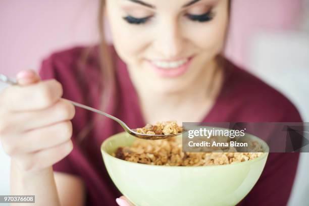 woman eating cereal in a bowl. debica, poland - anna bizon foto e immagini stock