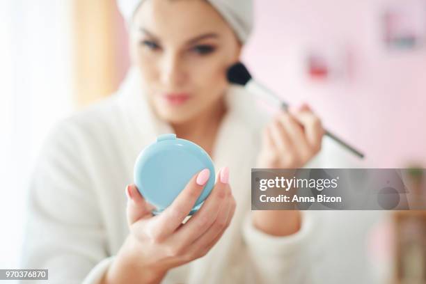 young woman doing make up at the morning. debica, poland - anna bizon stock pictures, royalty-free photos & images