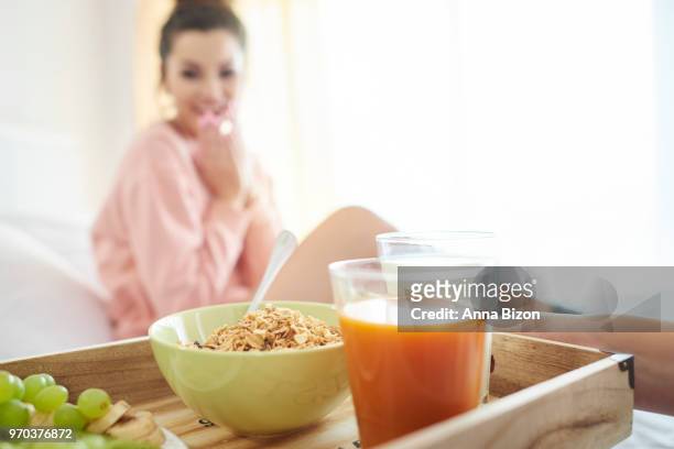 close up of tray of breakfast being served to woman in background. debica, poland - anna bizon stock pictures, royalty-free photos & images