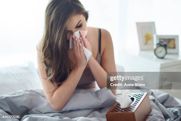 young woman blowing nose in tissue. debica, poland - anna bizon stock pictures, royalty-free photos & images