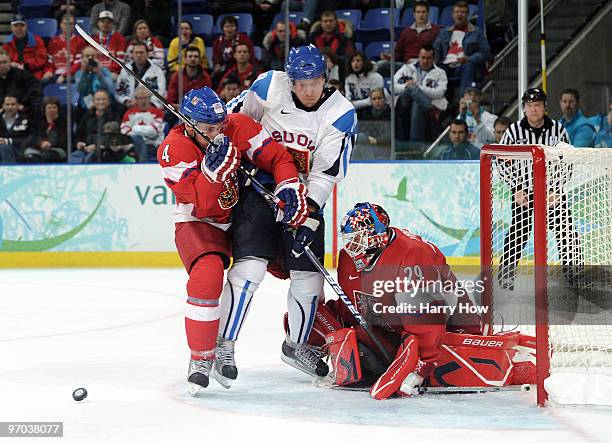 Zbynek Michalek and Tomas Vokoun of Czech Republic attempt to knock Niklas Hagman of Finland out of the crease during the ice hockey men's quarter...