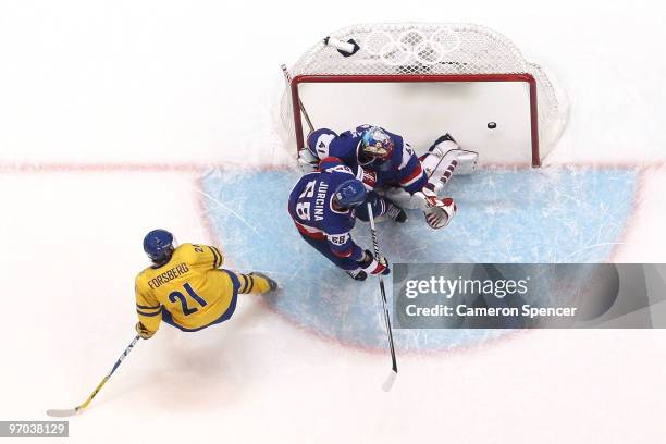 Peter Forsberg of Sweden scores past goalkeeper Jaroslav Halak of Slovakia during the ice hockey men's quarter final game between Sweden and Slovakia...