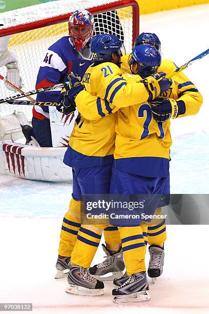 Peter Forsberg of Sweden celebrates with his team mates after he scored past goalkeeper Jaroslav Halak of Slovakia during the ice hockey men's...