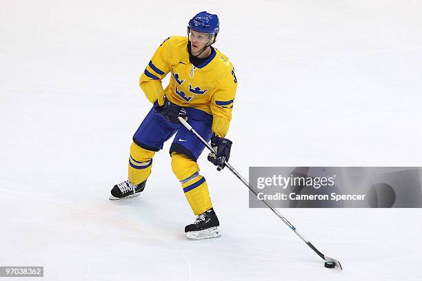 Tobias Enstrom of Sweden moves the puck during the ice hockey men's quarter final game between Sweden and Slovakia on day 13 of the Vancouver 2010...