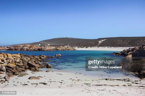 the cold, crystal clear waters of the atlantic ocean lap the warm rocks and white sandy beaches of the popular camp site at tieties bay (aka tietiesbaai) on the west coast of the western cape in south africa. - south atlantic ocean stock pictures, royalty-free photos & images