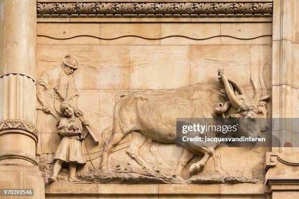 monumental architecture in budapest, hungary: sculpture on a facade front (detail) - ancient plow stock pictures, royalty-free photos & images