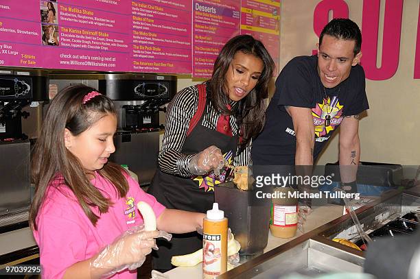 Singer Melody Thornton of the Pussycat Dolls prepares a delicious drink with fan Breanna Ceballos at the launching of her "Melody Milkshake" for...