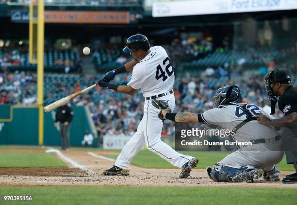 Jeimer Candelario of the Detroit Tigers pops the ball up as catcher Gary Sanchez of the New York Yankees works behind the plate during game two of a...