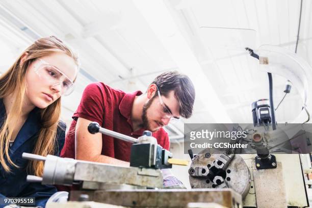 team of engineering students working at a science lab - engineering student stock pictures, royalty-free photos & images