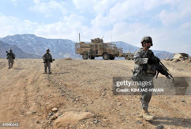 In this February 23, 2010 photograph, US soldiers with the 4th Infantry Division, 4th Infantry Brigade Combat Team, Alpha Company, patrol in...