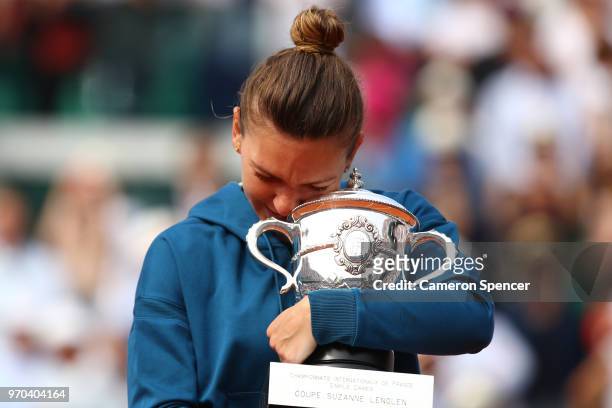 Simona Halep of Romania hugs the trophy as she celebrates victory following the ladies singles final against Sloane Stephens of The United States...