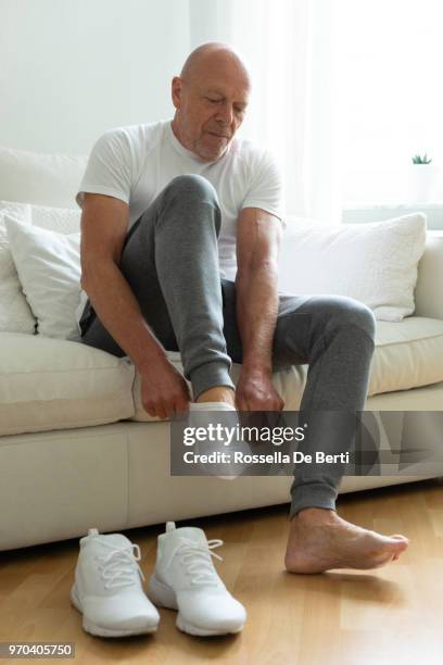 senior man getting ready for workout - getting dressed stock pictures, royalty-free photos & images