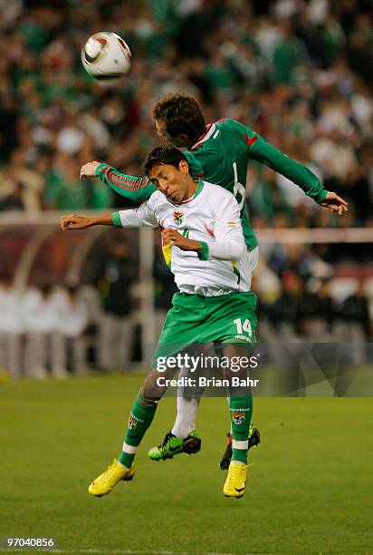 Gerardo Torrado of Mexico heads the ball over Marvin Bejarano of Bolivia during a friendly match at Candlestick Park in preparation for the 2010 FIFA...