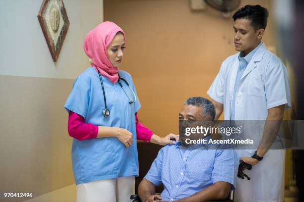 female muslim doctor consulting with a patient - hospital orderly stock pictures, royalty-free photos & images