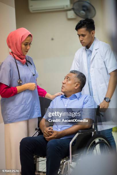 female muslim doctor consulting with a patient - hospital orderly stock pictures, royalty-free photos & images