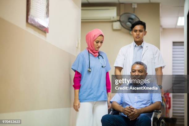 female muslim doctor consulting with a patient - hospital orderly stock pictures, royalty-free photos & images