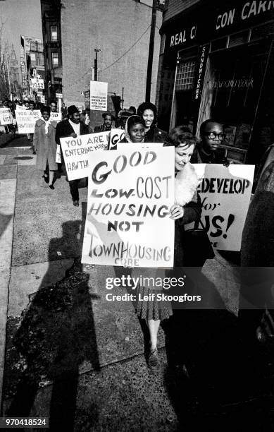 View of demonstrators, many with signs, as they march along South Broad Street during a protest about fair housing, Philadelphia, Pennsylvania, 1963....