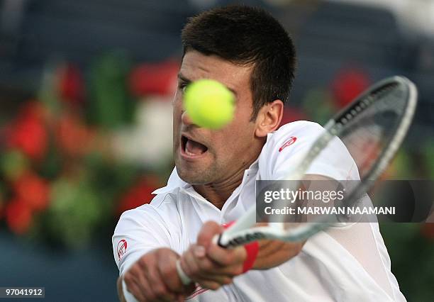 Serbia's Novak Djokovic returns to his compatriot Viktor Troicki during their match in the second round of the ATP Dubai Open tennis championship in...