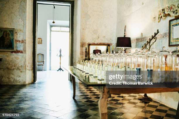 table in perfumery filled with fragrances for customer to sample - perfumería fotografías e imágenes de stock